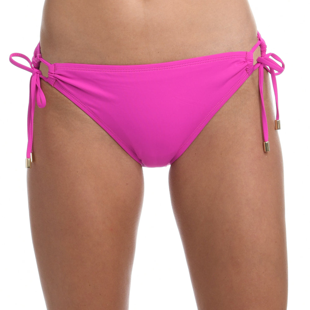 Model is wearing a orchid colored side-tie hipster swimsuit bottom from our Best-Selling Island Goddess collection.