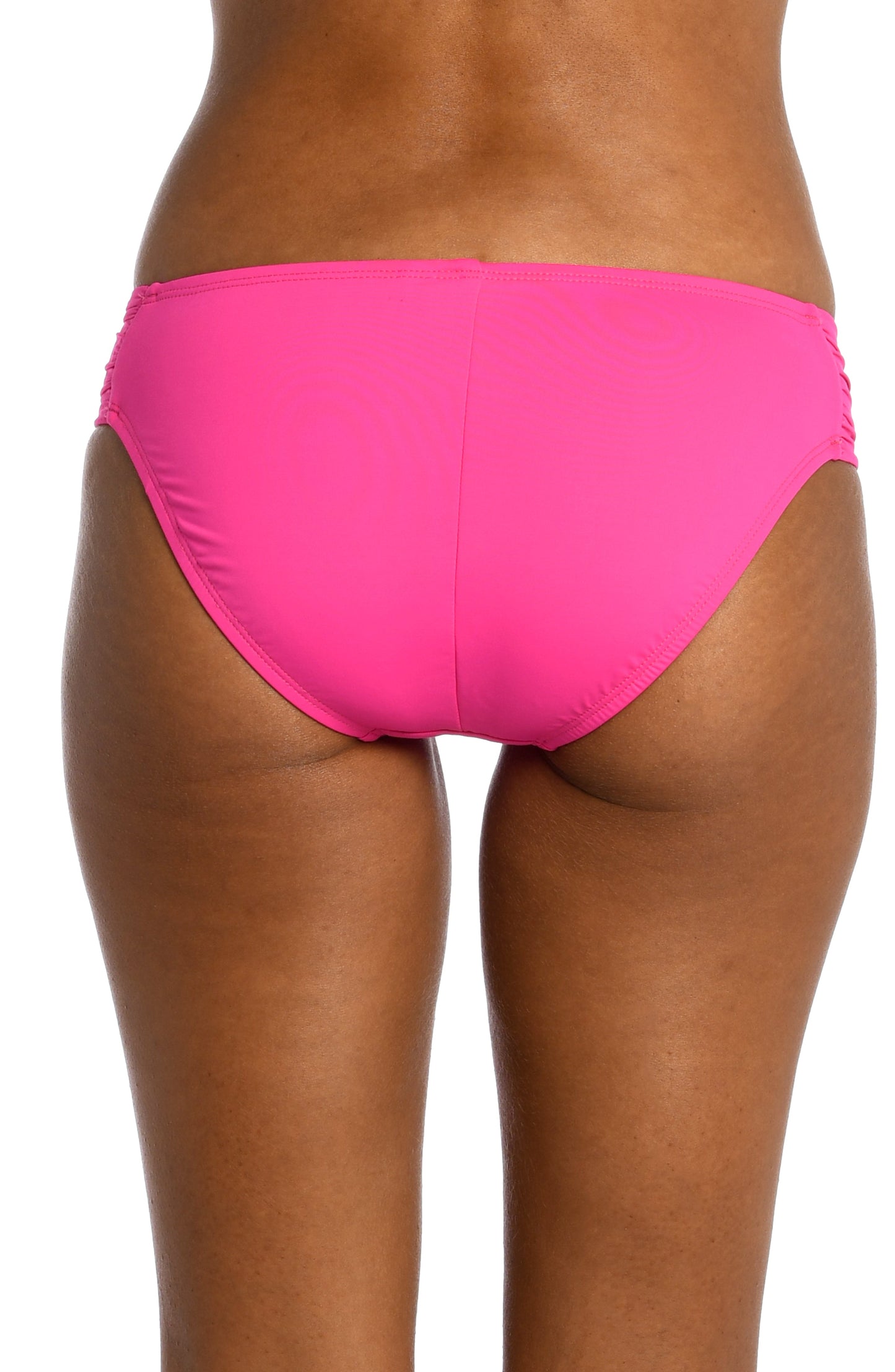 Model is wearing a pop pink colored side-shirred swimsuit bottom from our Best-Selling Island Goddess collection.