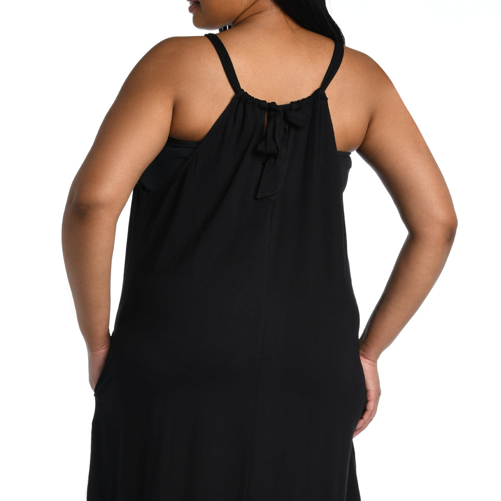 
                  
                    Model is wearing a black mini dress swimsuit cover up from our Draped Darling collection.
                  
                