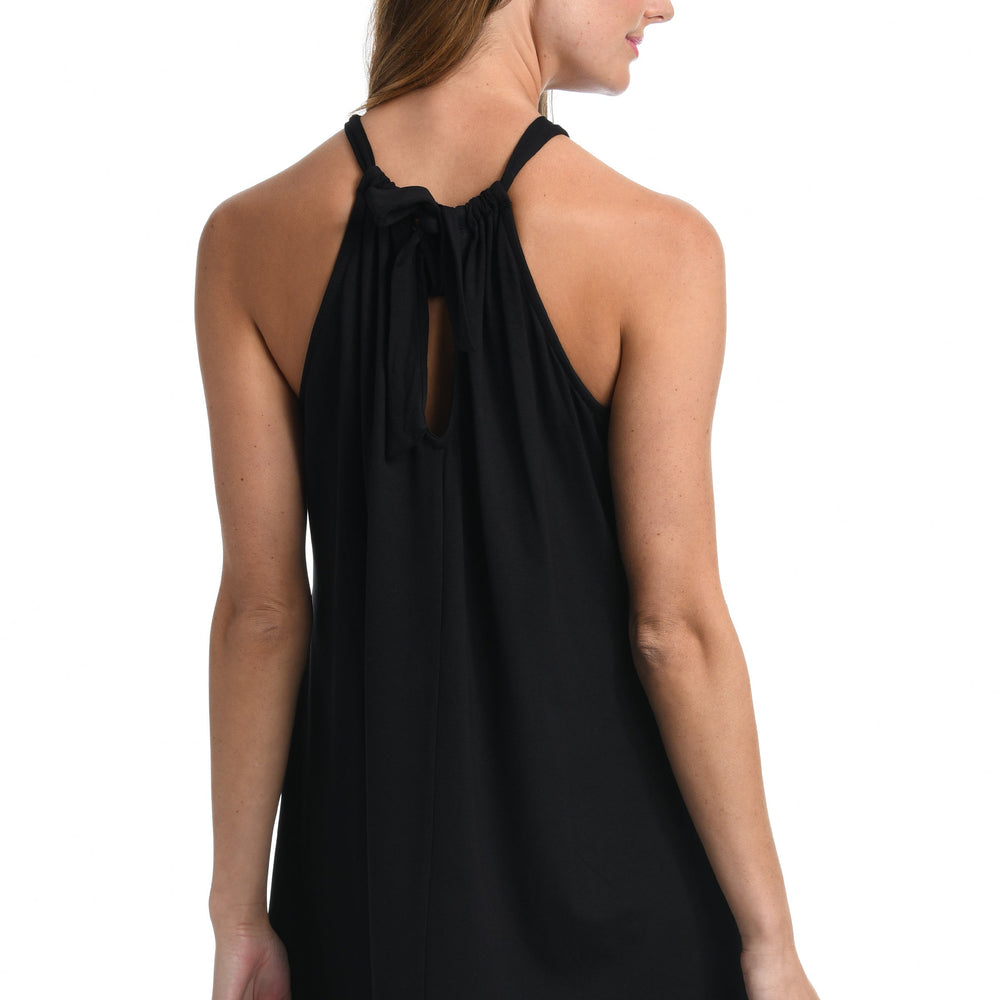 Model is wearing a black mini dress swimsuit cover up from our Draped Darling collection.