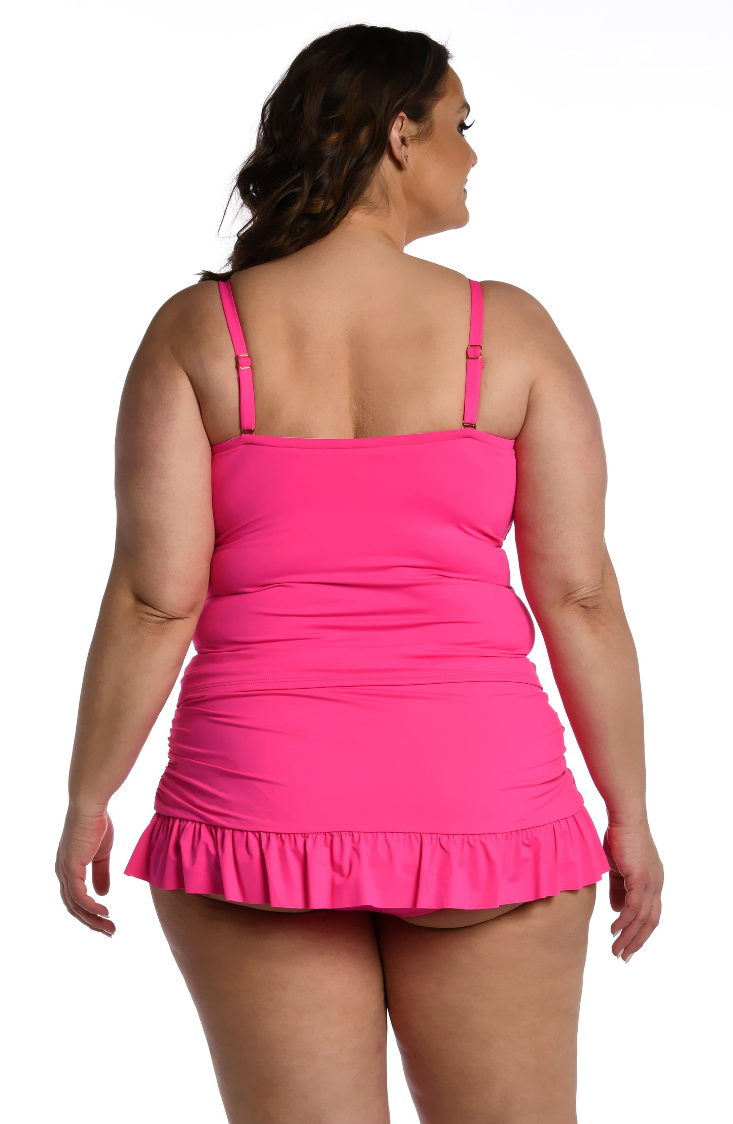 Model is wearing a pop pink colored bandeau tankini swimsuit top from our Best-Selling Island Goddess collection.