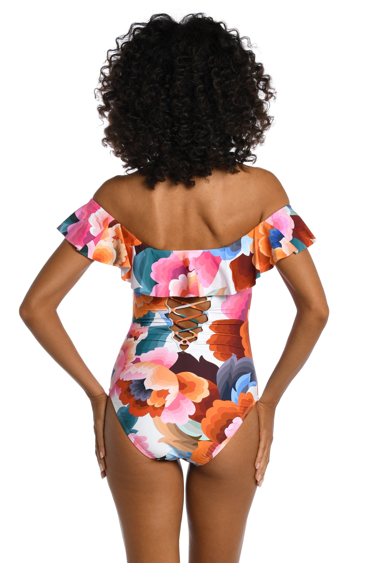 Model is wearing a multi colored floral printed off shoulder ruffle one piece from our Floral Rhythm collection!