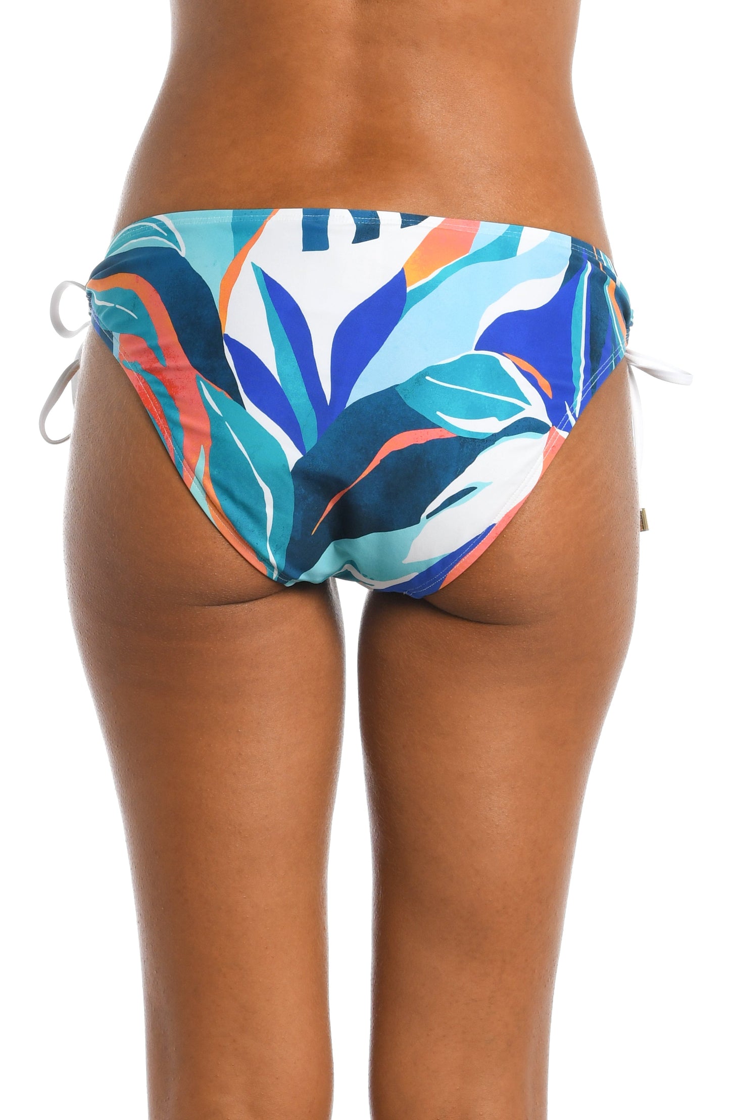 Model is wearing a blue multi colored tropical printed side tie hipster bottom from our Coastal Palms collection!