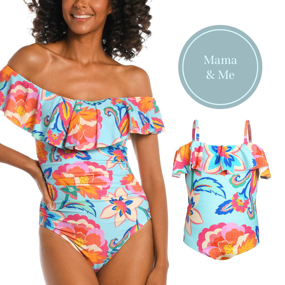 
                  
                    Model is wearing a light blue multi colored tropical printed off shoulder one piece from our Breezy Beauty collection!
                  
                