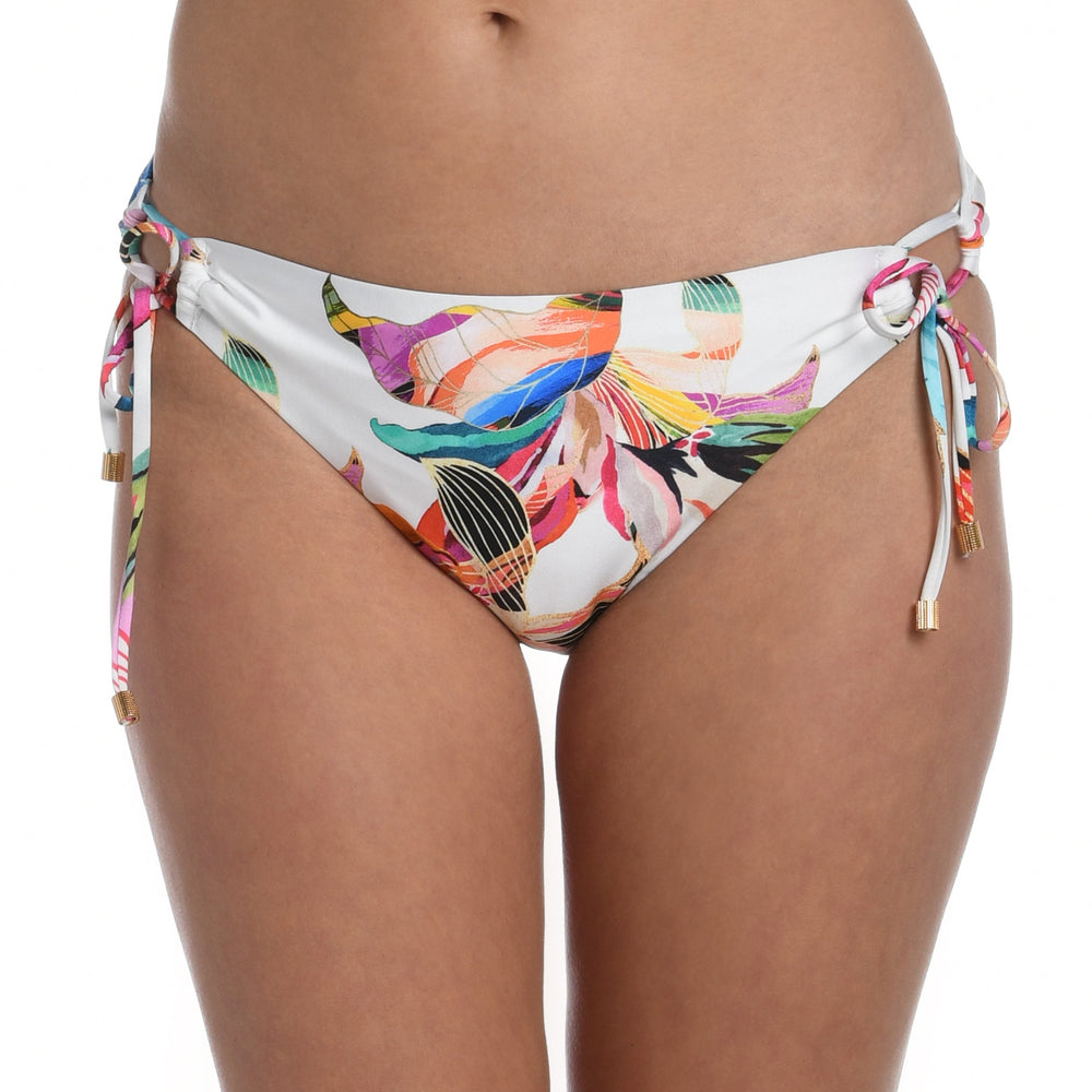 Model is wearing a multi colored tropical printed side tie hipster bottom from our Paradise City collection!