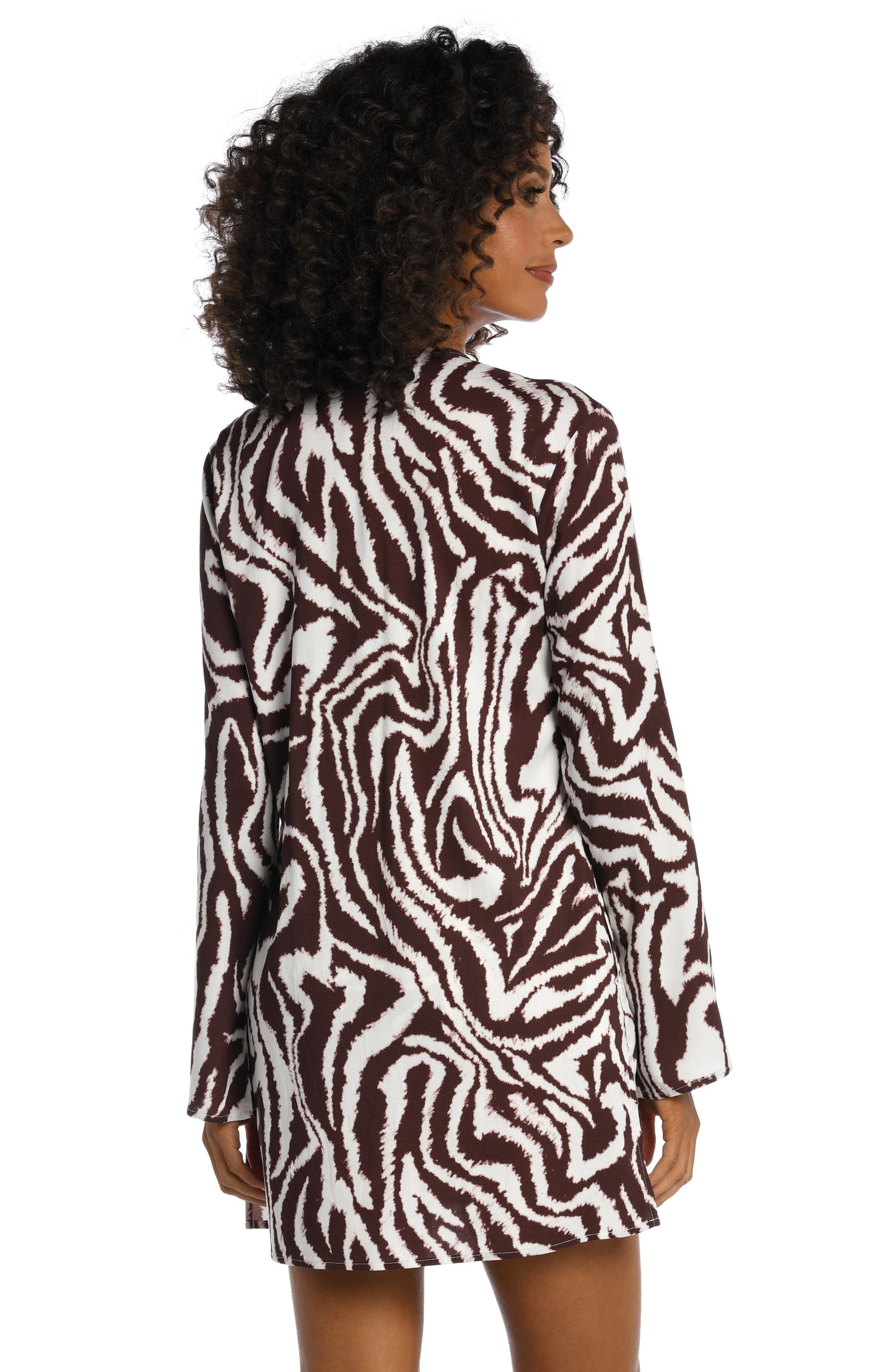 Model is wearing a java colored animal printed v-neck tunic cover up in our Fierce Lines collection!