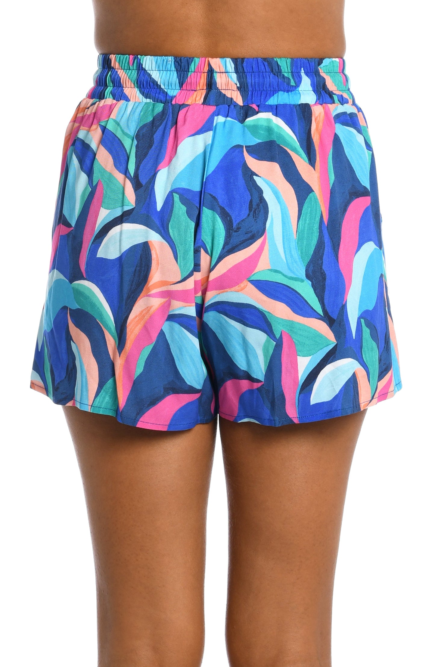 Model is wearing a bold paint-like stroke of vibrant dark colors printed on these beach short bottoms from our Painted Leaves collection!