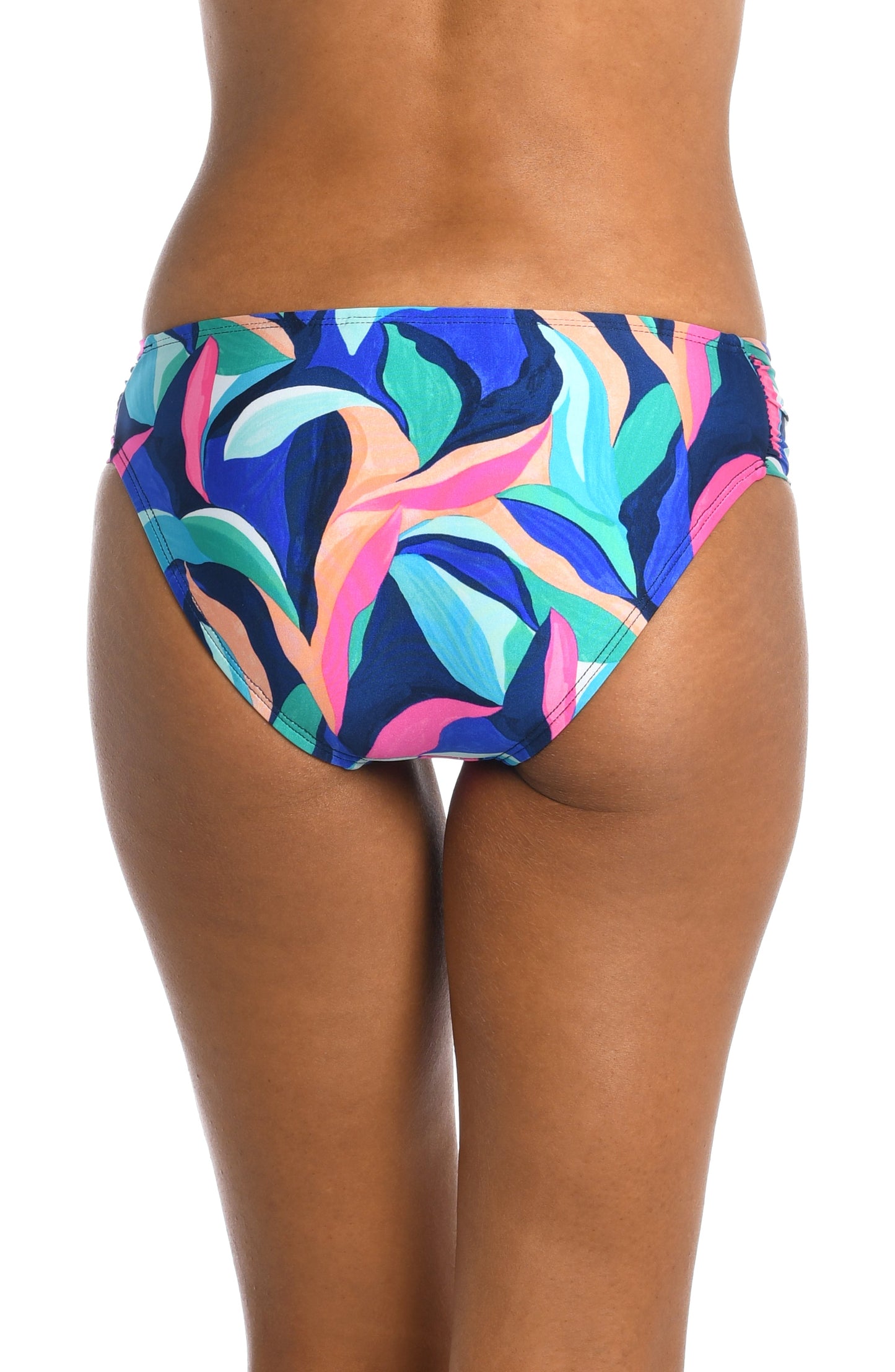 Model is wearing a bold paint-like stroke of vibrant dark colors printed on this side shirred hipster bottom from our Painted Leaves collection!