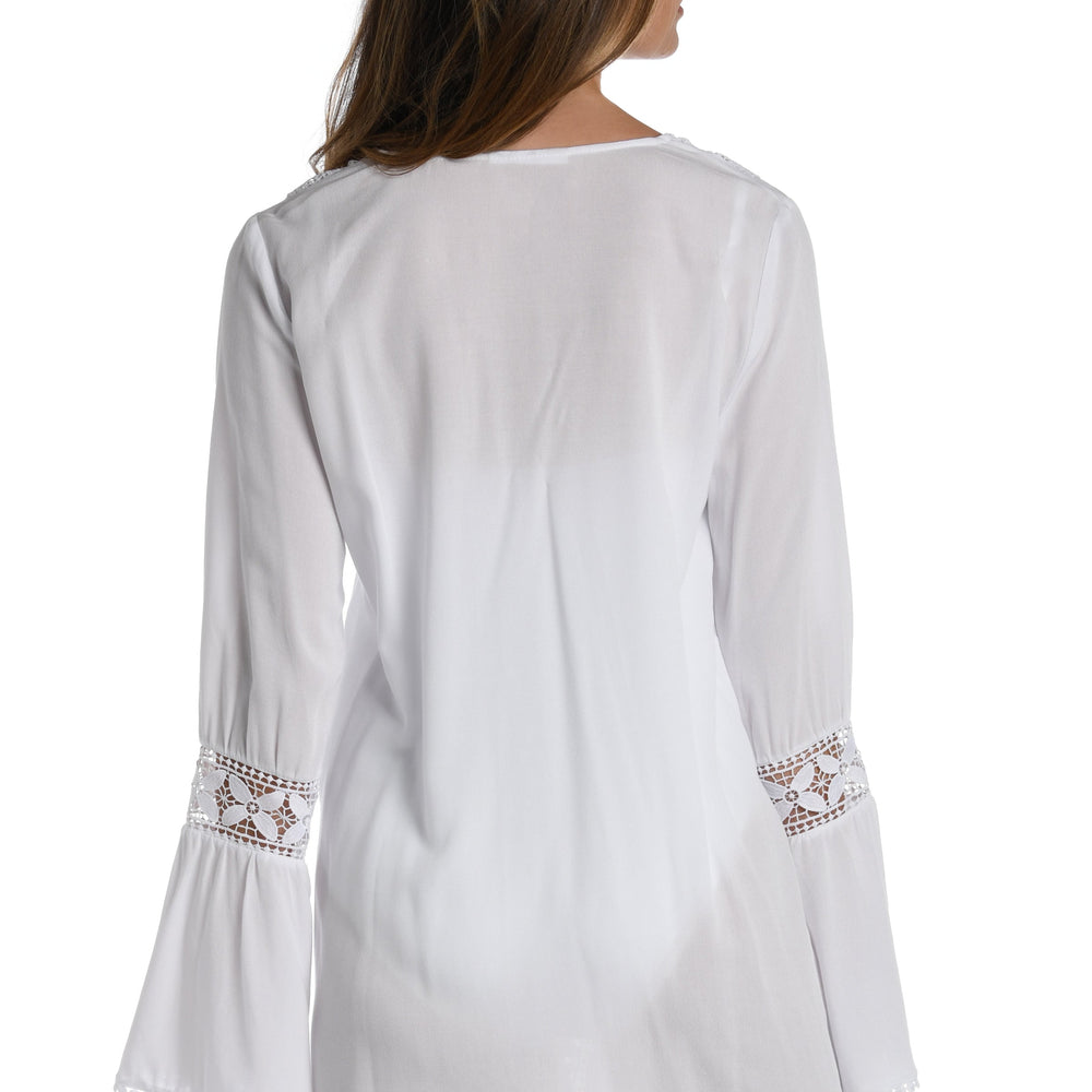 Model is wearing a crochet detailed pattern on this white v-neck tunic cover up from out Coastal Covers collection!