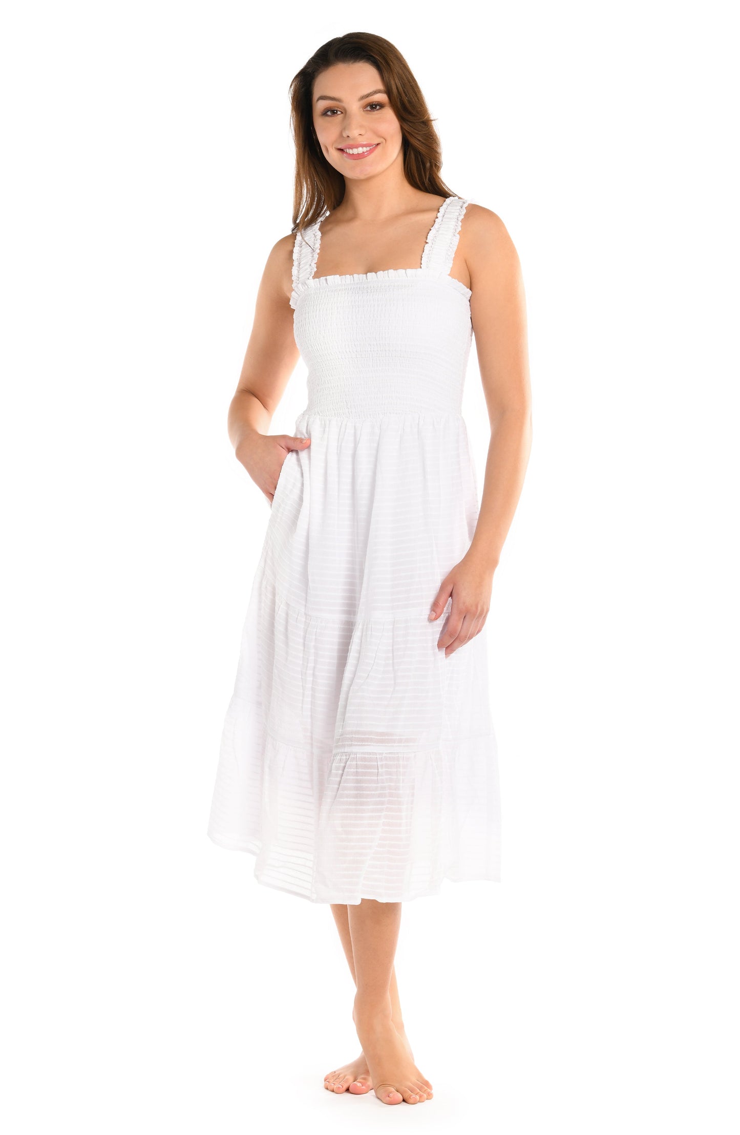 Model is wearing a solid white colored smocked tiered midi dress cover up from our Shadow Stripe collection.