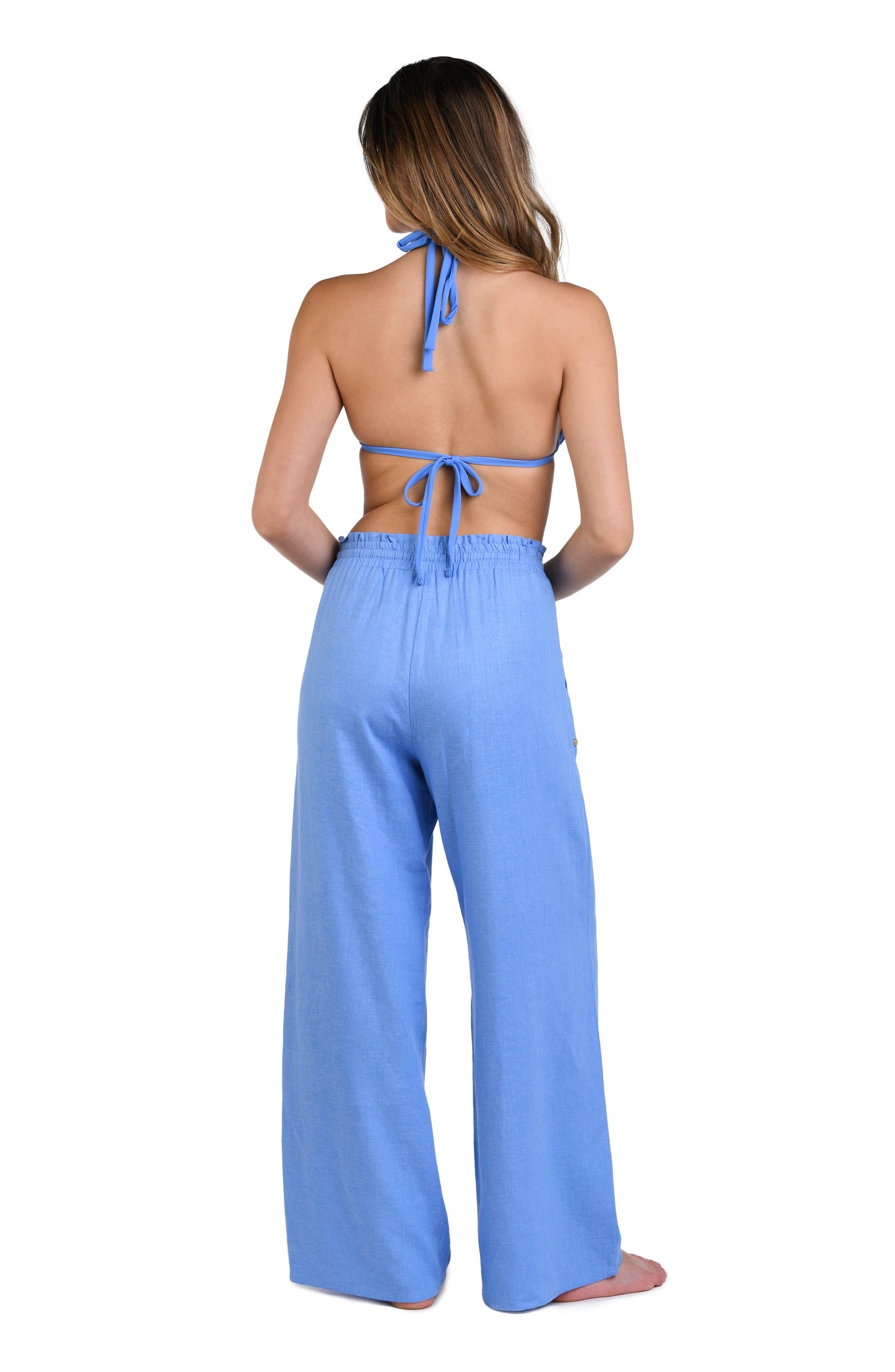 Model is wearing a solid chambray (light blue) colored beach pant cover up.