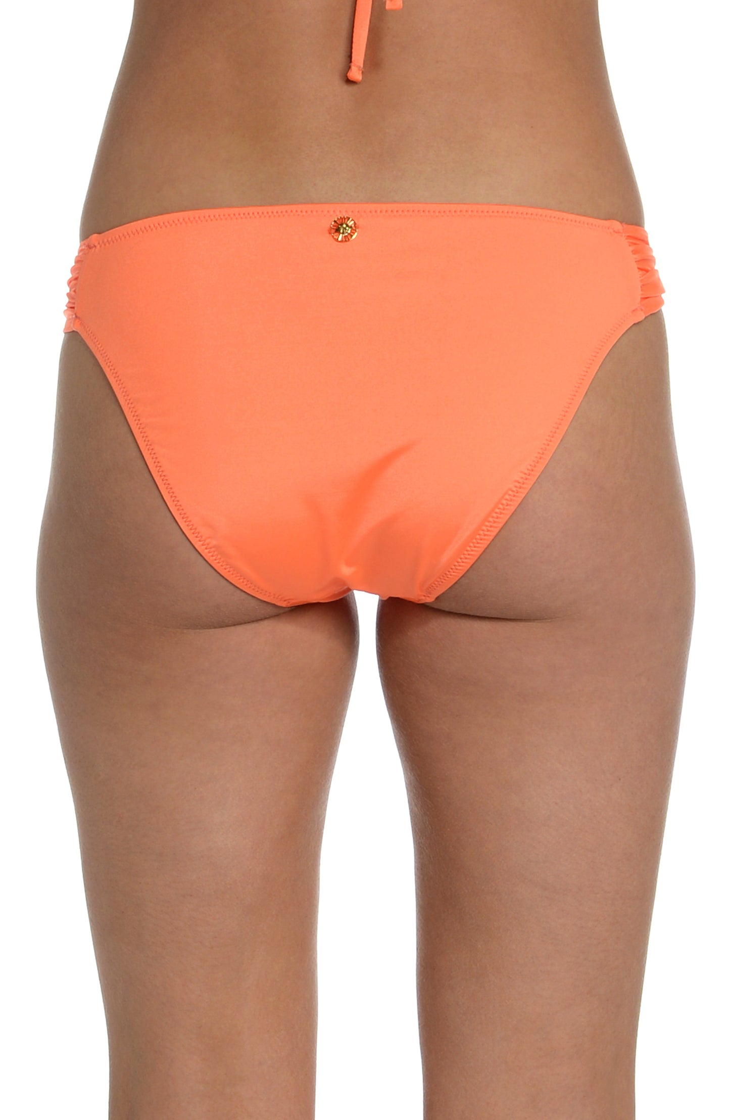 Model is wearing a solid bright coral colored side tie hipster bikini bottom from our Wanderlust Solids collection.