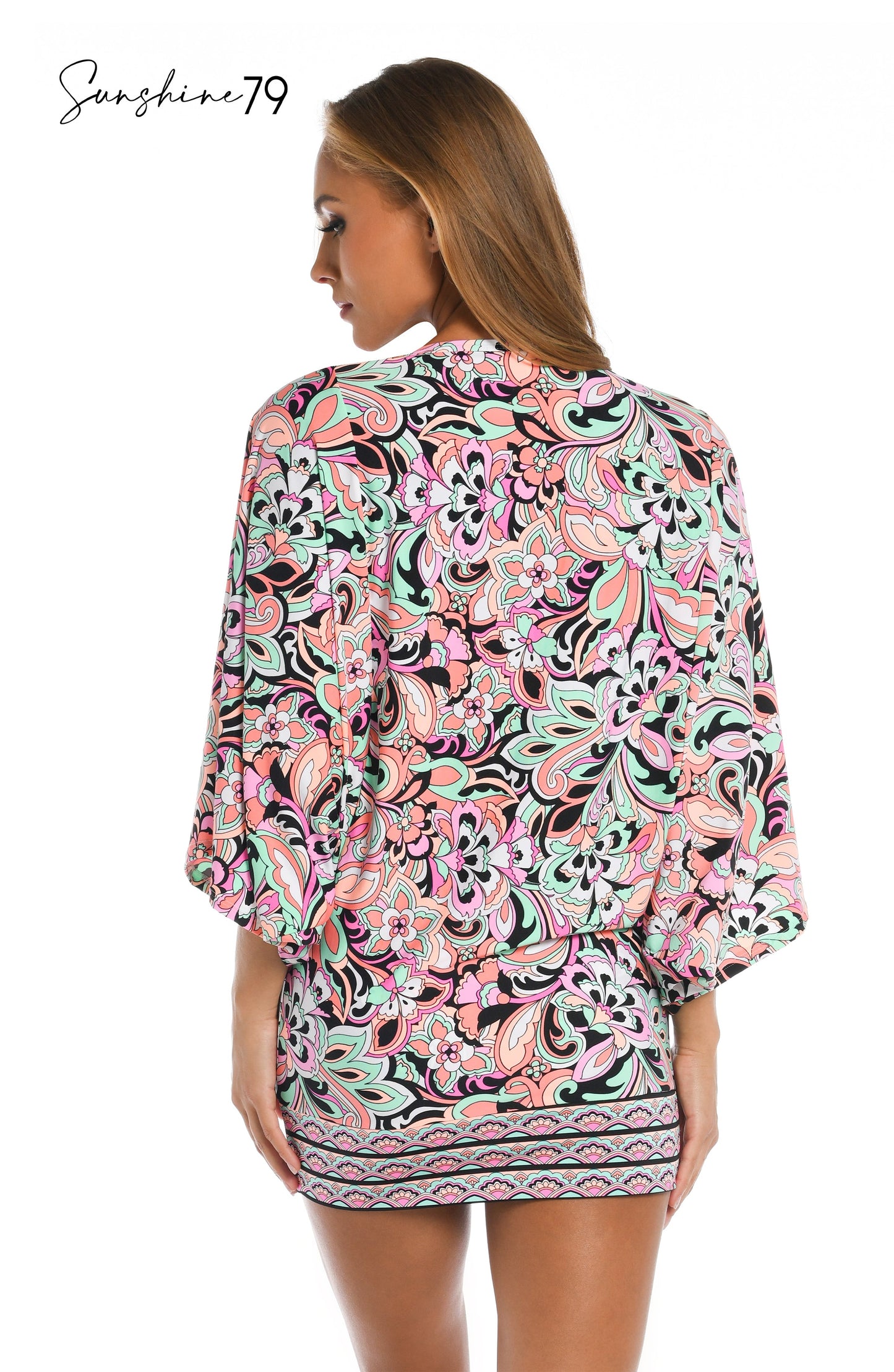 Model is wearing a pink multicolored paisley printed scoop neck tunic cover up from our Sunshine 79 brand.