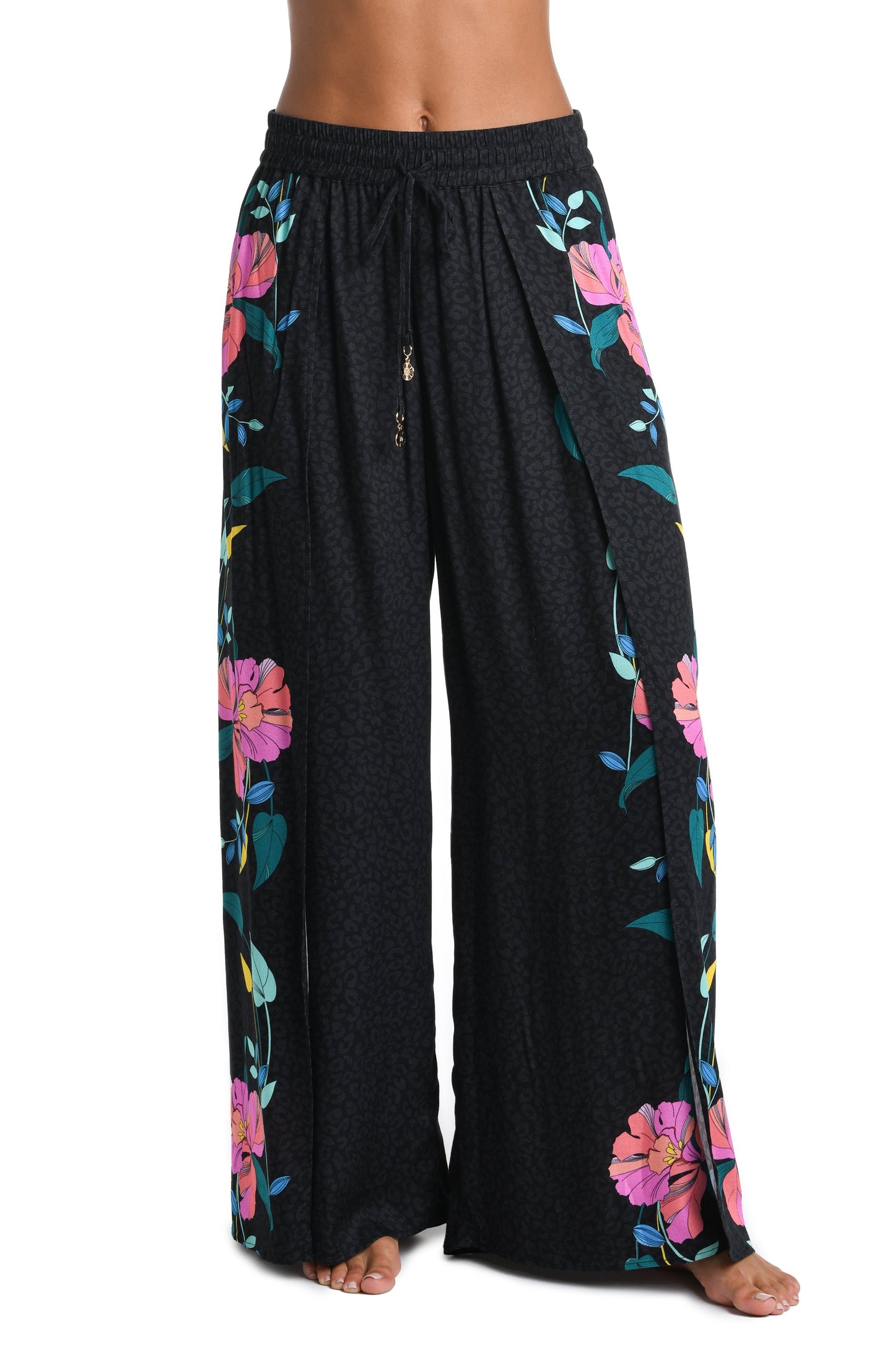 Model is wearing a black, pink, and green multicolored floral patterned Beach Pant