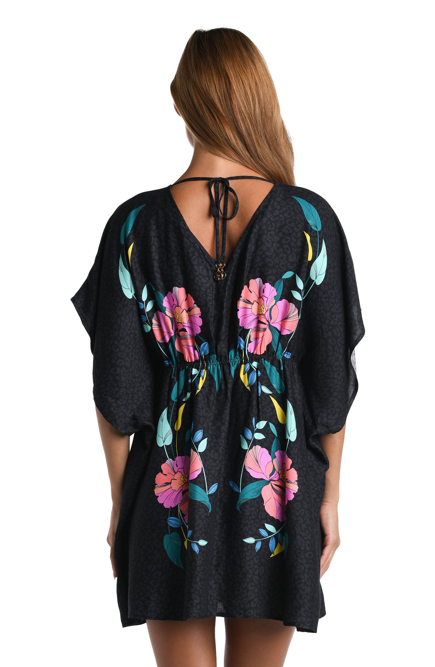 Model is wearing a black, pink, and green multicolored floral patterned V-Neck Tunic