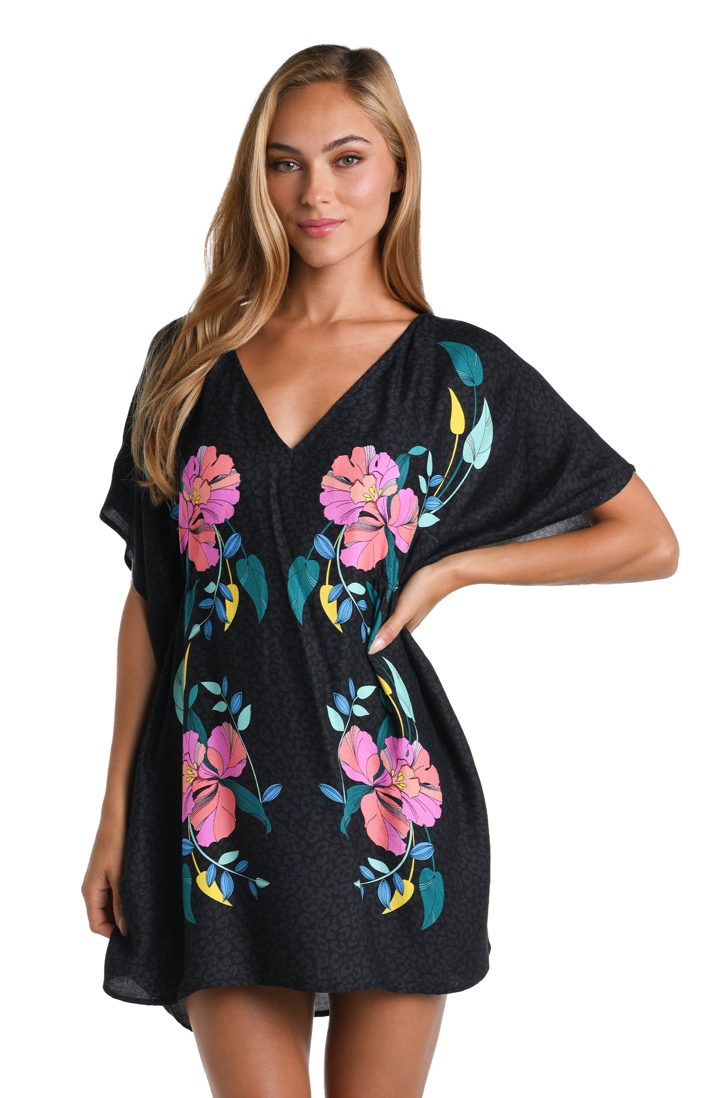 Model is wearing a black, pink, and green multicolored floral patterned V-Neck Tunic